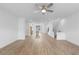 Bright open-concept living area with hardwood floors and a ceiling fan at 5448 Howington E Ct # 194, Buford, GA 30518