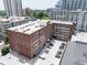 Brick building exterior featuring a parking lot and surrounding buildings in an urban neighborhood setting at 800 Peachtree Ne St # 8531, Atlanta, GA 30308