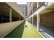 Exterior dog park area with artifical turf and adjacent to a parking garage and apartment building at 800 Peachtree Ne St # 8531, Atlanta, GA 30308
