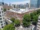 Brick condo building exterior with cityscape views and mature trees near city streets and high rise buildings at 800 Peachtree Ne St # 8531, Atlanta, GA 30308