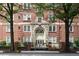 Beautiful brick apartment building with an ornate entrance and manicured landscaping at 800 Peachtree Ne St # 8531, Atlanta, GA 30308