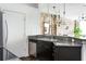 Modern kitchen with stainless steel appliances, granite countertops, and dark cabinetry with exposed brick accents at 800 Peachtree Ne St # 8531, Atlanta, GA 30308