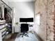 Small home office with exposed brick and an open closet for storage and organization at 800 Peachtree Ne St # 8531, Atlanta, GA 30308