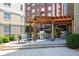 Outdoor grilling area featuring multiple grills, tables, and chairs within a fenced-in space at 800 Peachtree Ne St # 8531, Atlanta, GA 30308
