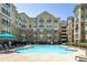 Inviting community pool surrounded by lounge chairs and multi-story apartment buildings at 800 Peachtree Ne St # 8531, Atlanta, GA 30308