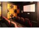 Home theater featuring tiered seating, a large screen, and stylish wall decor at 800 Peachtree Ne St # 8531, Atlanta, GA 30308