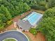 Aerial view of the community pool, clubhouse, playground, and surrounding green space at 1100 Carrington Pkwy, Villa Rica, GA 30180