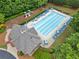Aerial view of the community pool area with blue lounge chairs and tables, plus a playground at 1100 Carrington Pkwy, Villa Rica, GA 30180