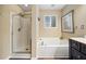 Bright bathroom featuring a tub and glass enclosed shower at 1100 Carrington Pkwy, Villa Rica, GA 30180