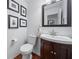 Powder room with wood vanity, framed art and a decorative mirror at 1100 Carrington Pkwy, Villa Rica, GA 30180