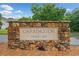 Stone community sign for Carrington at Mirror Lake, framed by lush landscaping at 1100 Carrington Pkwy, Villa Rica, GA 30180