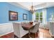 Charming dining room with blue walls, a chandelier, and wainscoting, perfect for Gathering meals at 1100 Carrington Pkwy, Villa Rica, GA 30180