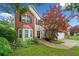 Charming two-story home featuring bay windows, brick accents, manicured lawn, and mature landscaping at 1100 Carrington Pkwy, Villa Rica, GA 30180