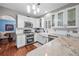 Bright kitchen features stainless steel appliances, granite countertops, white cabinetry and a farmhouse sink at 1100 Carrington Pkwy, Villa Rica, GA 30180