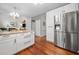 Modern kitchen with stainless steel refrigerator and center island open to the living room at 1100 Carrington Pkwy, Villa Rica, GA 30180