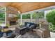 Inviting outdoor living area featuring a brick fireplace and comfortable seating with covered patio at 1100 Carrington Pkwy, Villa Rica, GA 30180