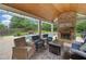 Inviting outdoor living area featuring a brick fireplace, outdoor seating, and a beautiful swimming pool at 1100 Carrington Pkwy, Villa Rica, GA 30180