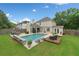 Beautiful in-ground pool with a seating area and lush landscaping, offering a private oasis in the backyard at 1100 Carrington Pkwy, Villa Rica, GA 30180