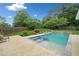 Backyard pool with a spa and a lush green lawn, surrounded by a wooden fence at 1100 Carrington Pkwy, Villa Rica, GA 30180