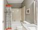 Cozy bathroom with a shower and tub combination with tile surround, along with a vanity and marble counter at 1386 Sheffield Glen Ne Way, Atlanta, GA 30329