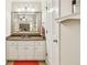 Bathroom featuring a granite countertop vanity, framed mirror, and neutral paint at 1386 Sheffield Glen Ne Way, Atlanta, GA 30329