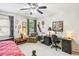 Bedroom and office combination with light carpet, fan, and a workspace at 1386 Sheffield Glen Ne Way, Atlanta, GA 30329