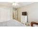 Bedroom featuring neutral walls, ceiling fan, closet, and a TV on the dresser at 1386 Sheffield Glen Ne Way, Atlanta, GA 30329