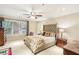 Comfortable bedroom with carpet floors, a ceiling fan, and large windows for ample natural light at 1386 Sheffield Glen Ne Way, Atlanta, GA 30329