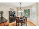 Cozy dining area with natural light, stylish chandelier, and adjacent breakfast bar at 1386 Sheffield Glen Ne Way, Atlanta, GA 30329