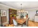 Dining area with decorative hutch, stylish chandelier, and hardwood floors at 1386 Sheffield Glen Ne Way, Atlanta, GA 30329