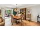 Dining area with hardwood floors, elegant chandelier, and access to the sunroom at 1386 Sheffield Glen Ne Way, Atlanta, GA 30329