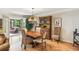 Bright dining room featuring hardwood floors, a wooden table, and a decorative cabinet at 1386 Sheffield Glen Ne Way, Atlanta, GA 30329