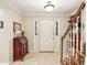 Welcoming foyer featuring tile flooring, stairs, and a classic wooden secretary desk at 1386 Sheffield Glen Ne Way, Atlanta, GA 30329