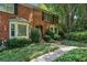 Beautiful brick townhome with lush greenery, bay window, and inviting walkway at 1386 Sheffield Glen Ne Way, Atlanta, GA 30329