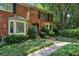 Lovely brick townhouse featuring a lush, landscaped front yard and classic architectural details at 1386 Sheffield Glen Ne Way, Atlanta, GA 30329