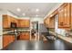 Well-equipped kitchen with black countertops, stainless appliances, and wood cabinets at 1386 Sheffield Glen Ne Way, Atlanta, GA 30329