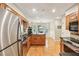 Open-concept kitchen featuring stainless appliances, wood floors, and ample counter space at 1386 Sheffield Glen Ne Way, Atlanta, GA 30329