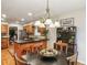 Open kitchen with wood cabinetry, island seating, and a view to the dining area at 1386 Sheffield Glen Ne Way, Atlanta, GA 30329