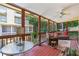 Spacious sunroom featuring wood floors, comfortable seating, and a view of lush greenery at 1386 Sheffield Glen Ne Way, Atlanta, GA 30329