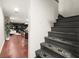 View of basement steps with patterned runner and basement living space with hardwood floors at 2148 Allgood Rd, Marietta, GA 30062