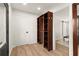 Spacious closet and dressing area featuring built-in shelving and storage and light wood floors at 2148 Allgood Rd, Marietta, GA 30062