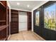 Spacious closet and dressing area featuring built-in shelving and a black exterior door at 2148 Allgood Rd, Marietta, GA 30062