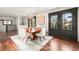 Dining space with natural lighting and hardwood floors, seamlessly flowing to an adjacent staircase and other living areas at 2148 Allgood Rd, Marietta, GA 30062