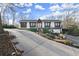 Inviting home exterior with a long driveway leading to the front entrance, and manicured landscaping at 2148 Allgood Rd, Marietta, GA 30062