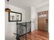 Upstairs hallway featuring hardwood floors, black railing, modern lighting fixture, and a door with glass pane windows at 2148 Allgood Rd, Marietta, GA 30062