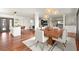 Open concept floor plan with hardwood floors connecting dining area, kitchen island, and living space with fireplace at 2148 Allgood Rd, Marietta, GA 30062
