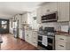 Modern kitchen featuring stainless steel appliances, a subway tile backsplash, ample counter space, and wood floors at 2148 Allgood Rd, Marietta, GA 30062