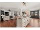 Stylish island with granite countertop, wood floors and open concept into the living area featuring a fireplace at 2148 Allgood Rd, Marietta, GA 30062