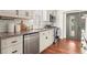 Elegant kitchen featuring subway tile backsplash, granite countertops, stainless appliances, and wood floors at 2148 Allgood Rd, Marietta, GA 30062