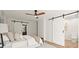 Spacious main bedroom featuring sliding barn doors, a ceiling fan, and great natural light at 2148 Allgood Rd, Marietta, GA 30062